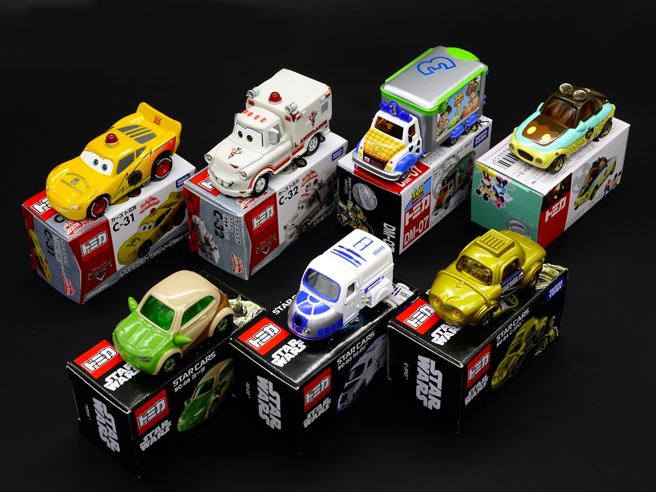 Vibrant display of die-cast toy cars from popular franchises like Star Wars and Disney.